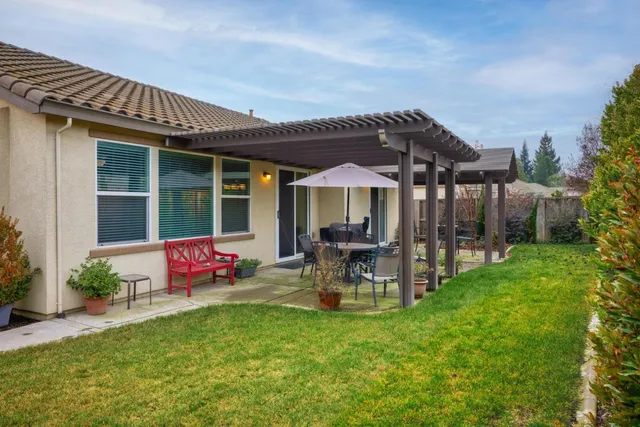 a view of a house with backyard porch and sitting area