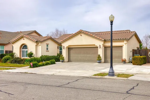 a view of a house with a patio and a yard