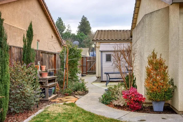 a view of a chair and table in the backyard of the house