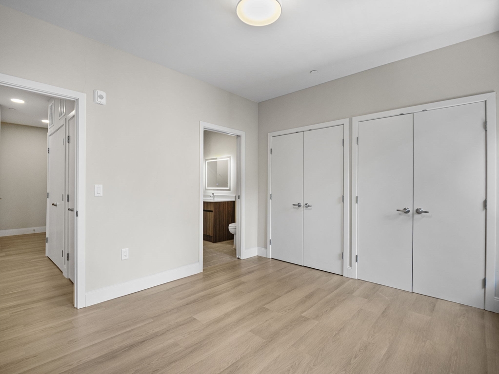 249 Corey Road, Unit 309 Boston, MA 02135 - Photo 19 of 29 a view of an empty room and wooden floor