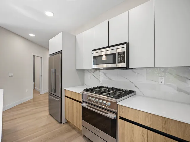 a kitchen with cabinets and steel stainless steel appliances