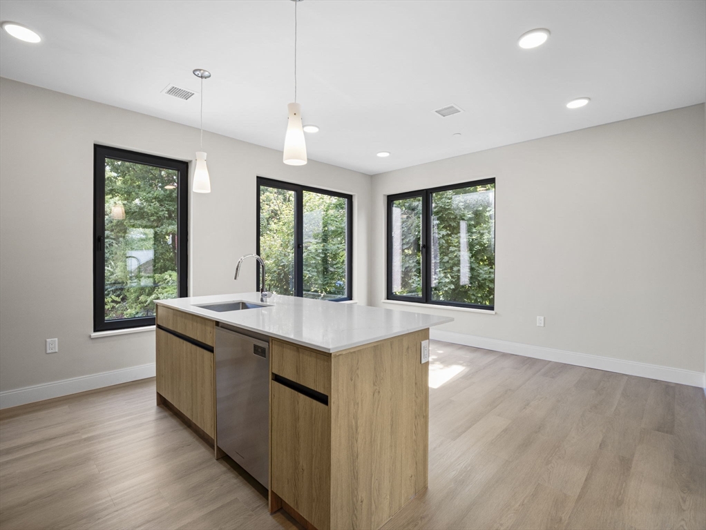 249 Corey Road, Unit 309 Boston, MA 02135 - Photo 6 of 29 a kitchen with a sink and large window