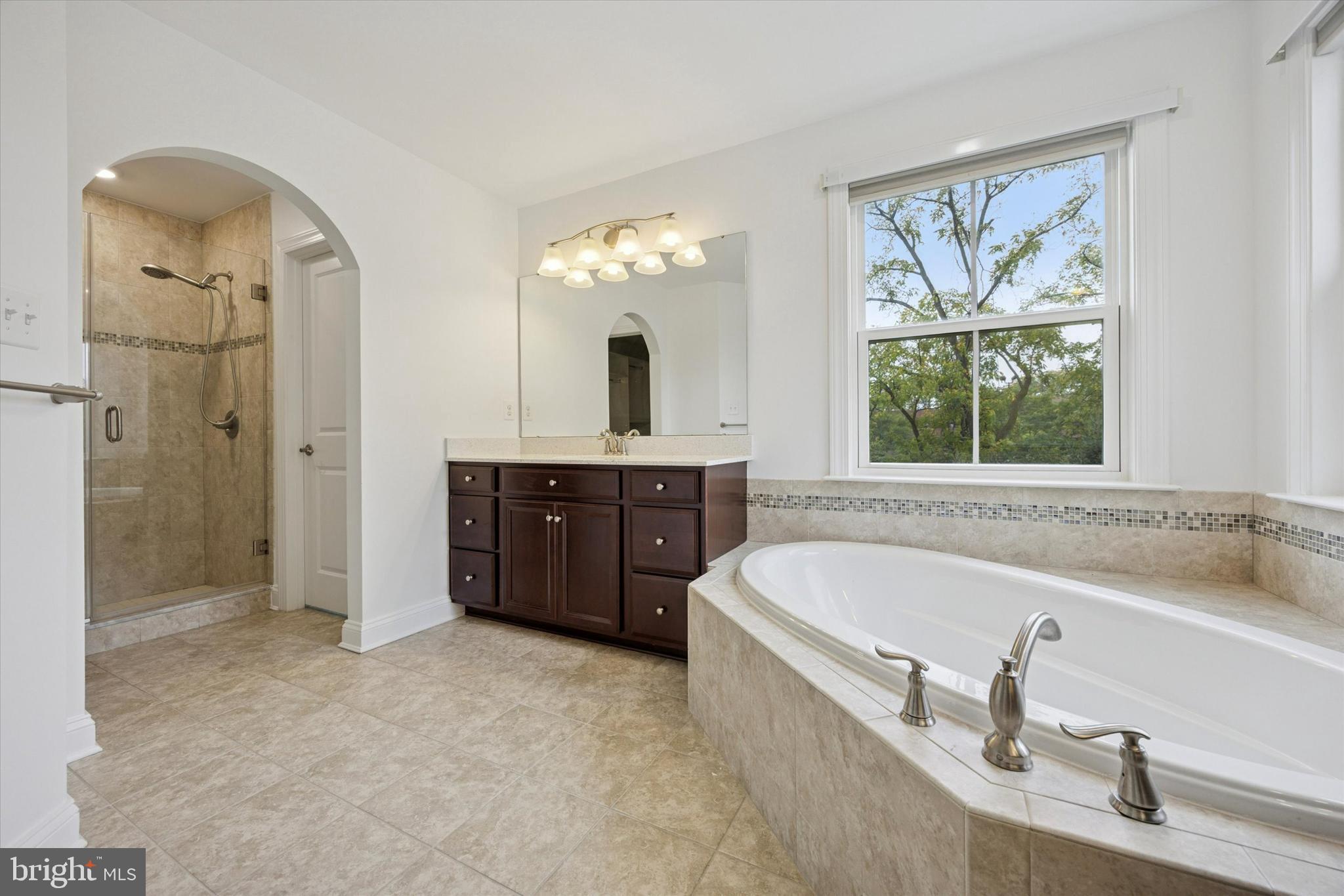 322 Quarry Point Road Malvern, PA 19355 - Photo 18 of 29 a bathroom with a tub a sink and mirror