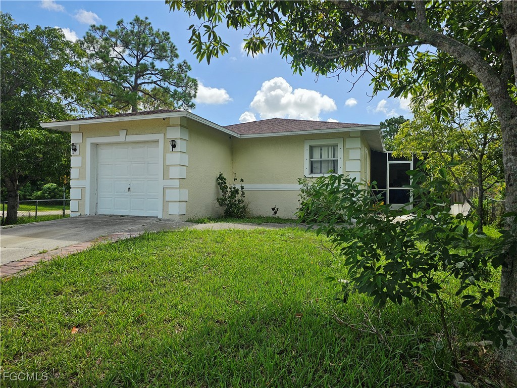 a view of a house with a yard and garage