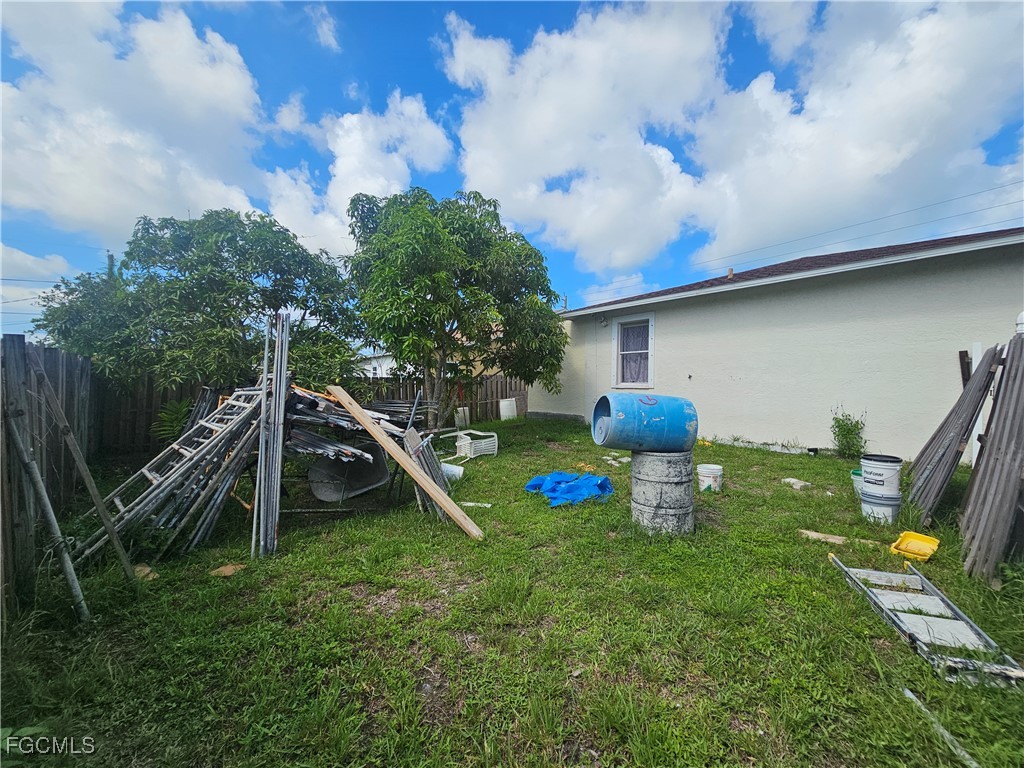2912 Woodside Avenue Naples, FL 34112 - Photo 13 of 16 a view of a backyard with plants and a large tree
