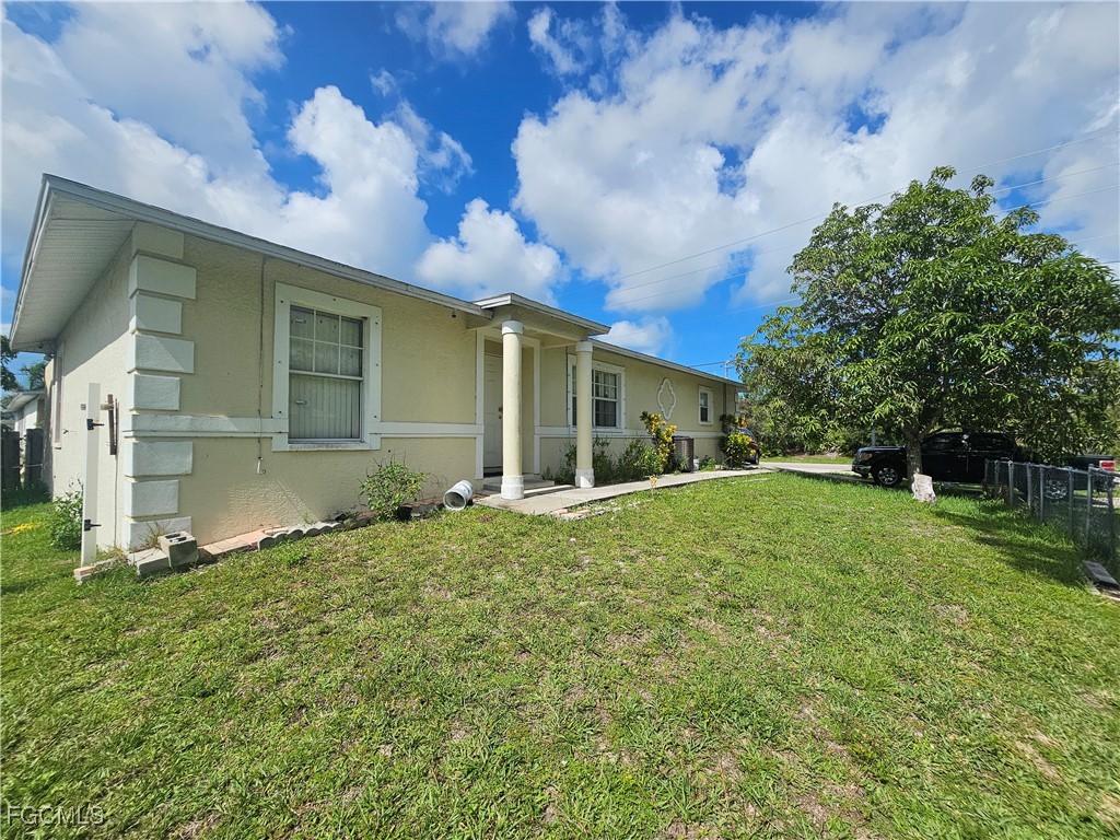 2912 Woodside Avenue Naples, FL 34112 - Photo 2 of 16 a view of a house with backyard and a tree