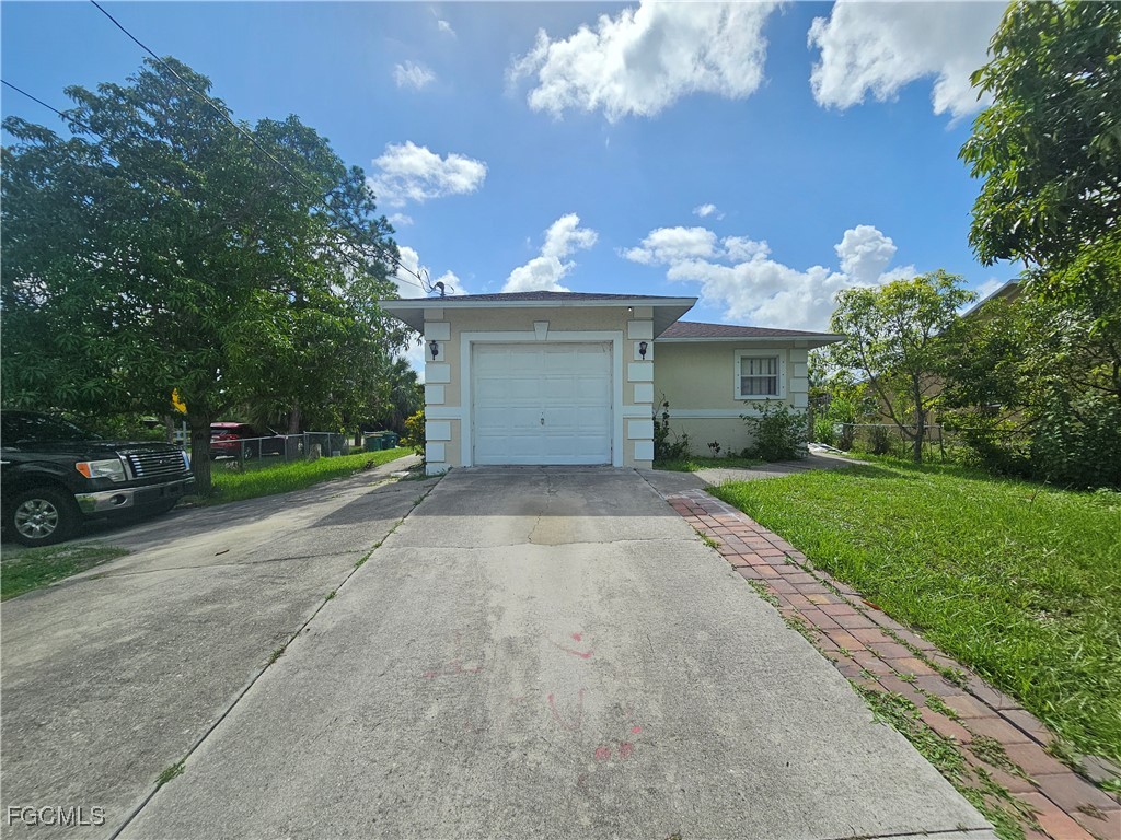 2912 Woodside Avenue Naples, FL 34112 - Photo 7 of 16 a front view of a house with garden