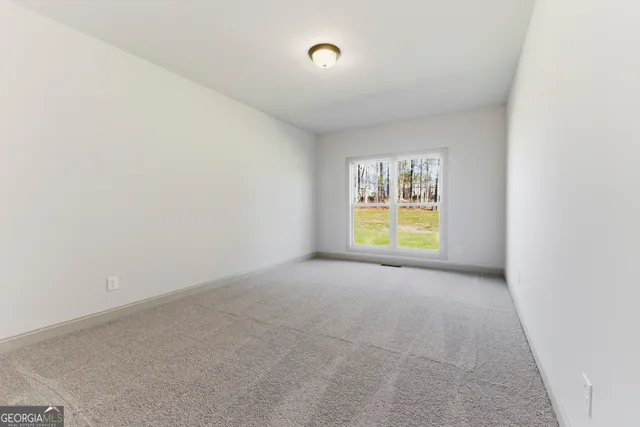 a bathroom with a granite countertop toilet sink and mirror