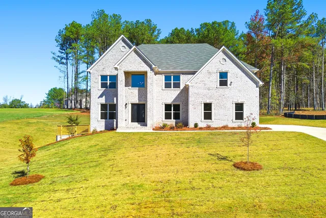 a bathroom with a tub and trees in the background
