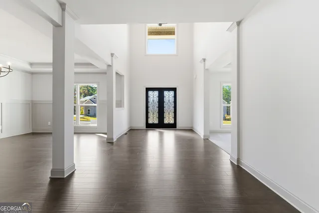 a view of livingroom with window wooden floor and brick wall
