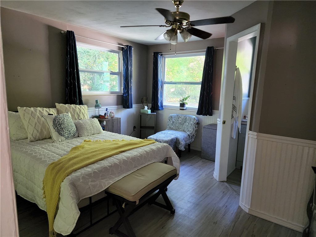 86007 Jones Road Yulee, FL 32097 - Photo 2 of 12 a bedroom with a bed a chandelier and a window