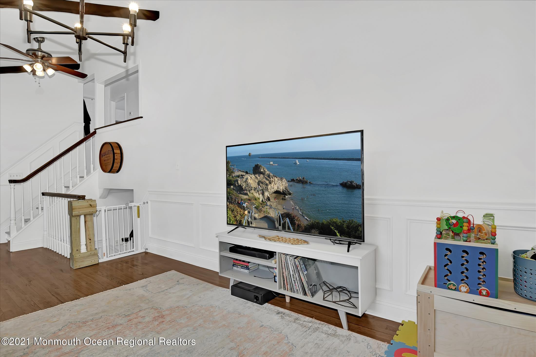 675 Harmony Road Middletown, NJ 07748 - Photo 11 of 25 a living room with furniture and a flat screen tv