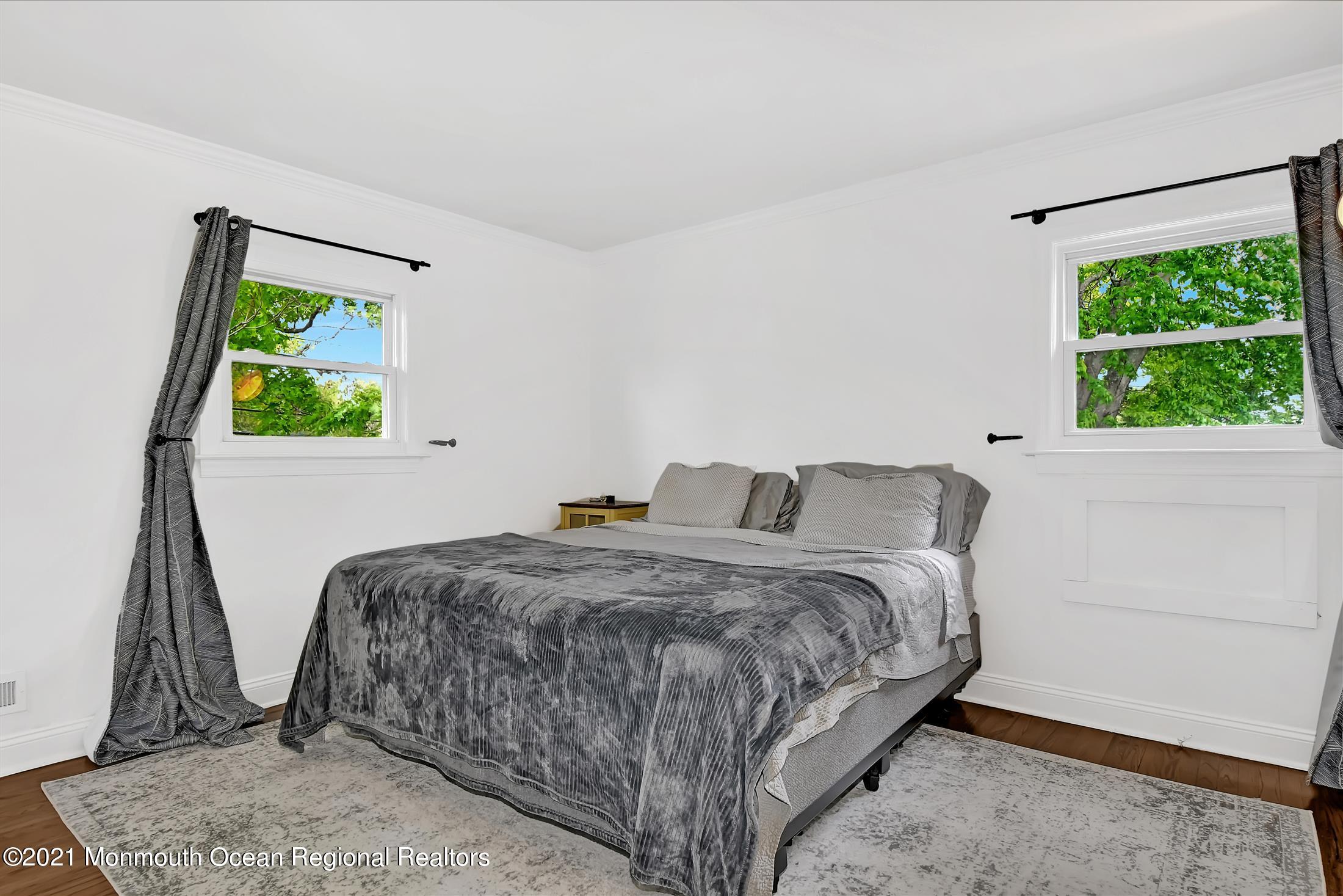 675 Harmony Road Middletown, NJ 07748 - Photo 14 of 25 a room with a bed a window and a potted plant