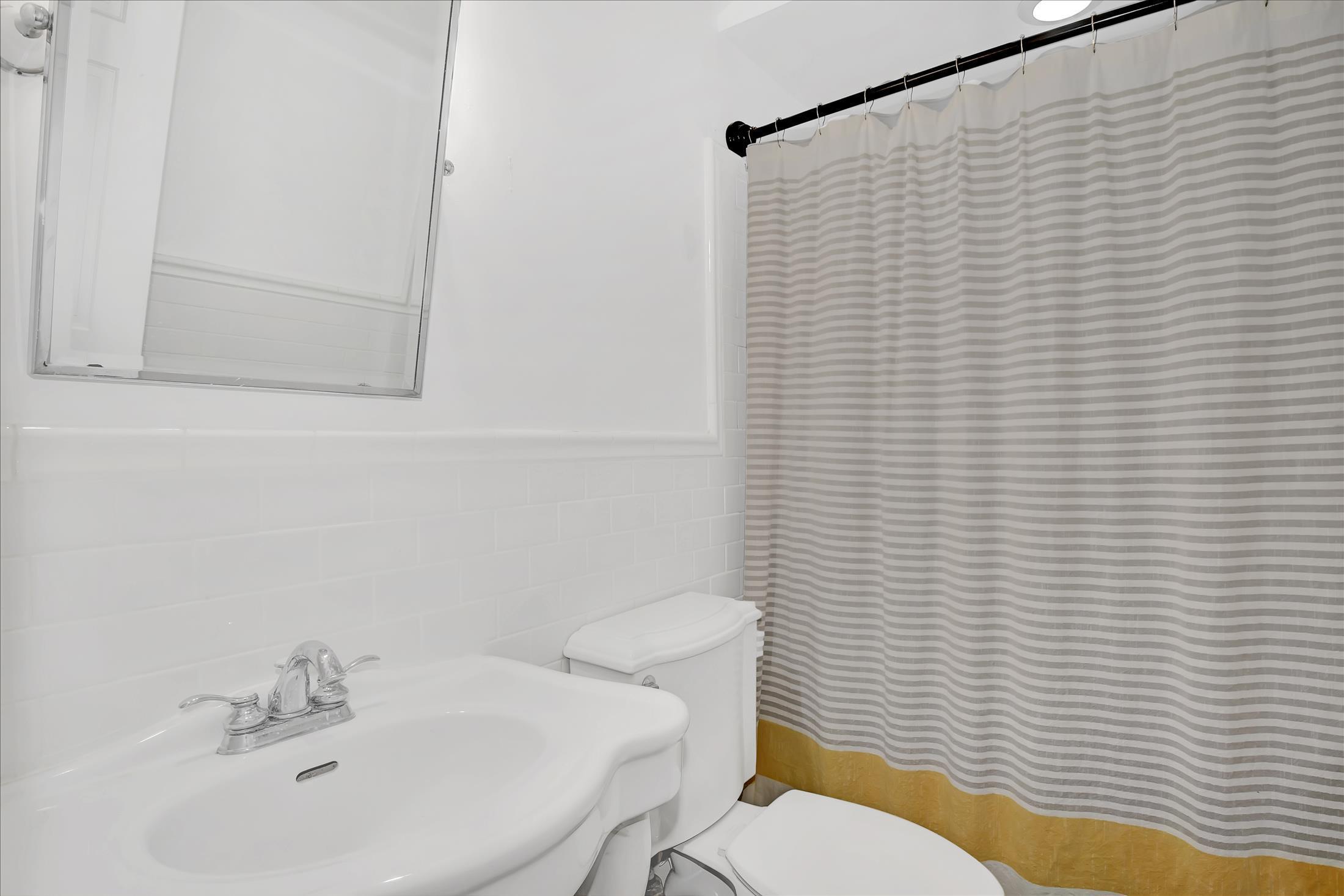 675 Harmony Road Middletown, NJ 07748 - Photo 15 of 25 a bathroom with a sink a toilet and mirror