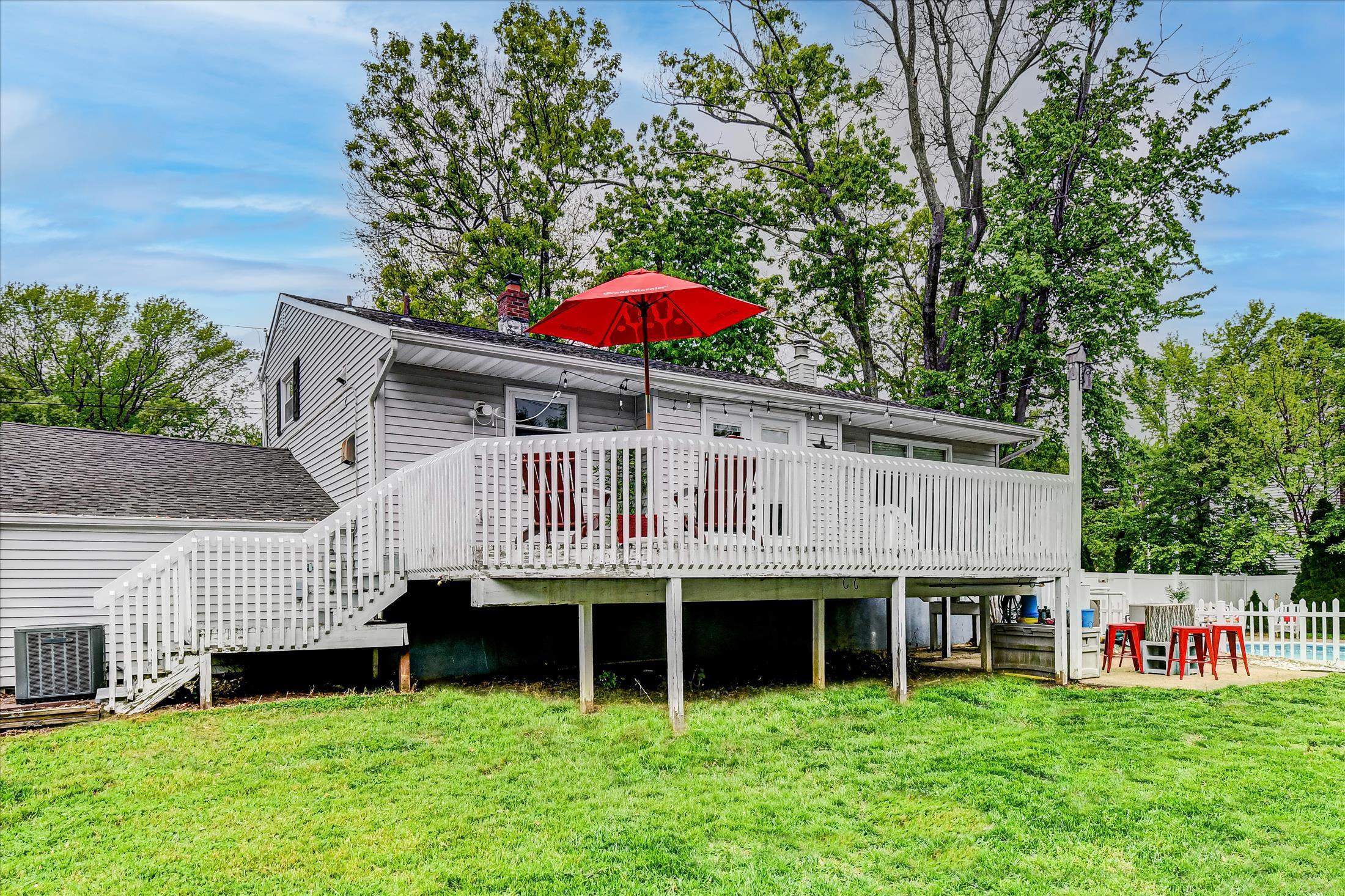 675 Harmony Road Middletown, NJ 07748 - Photo 20 of 25 a view of a house with a yard and sitting area