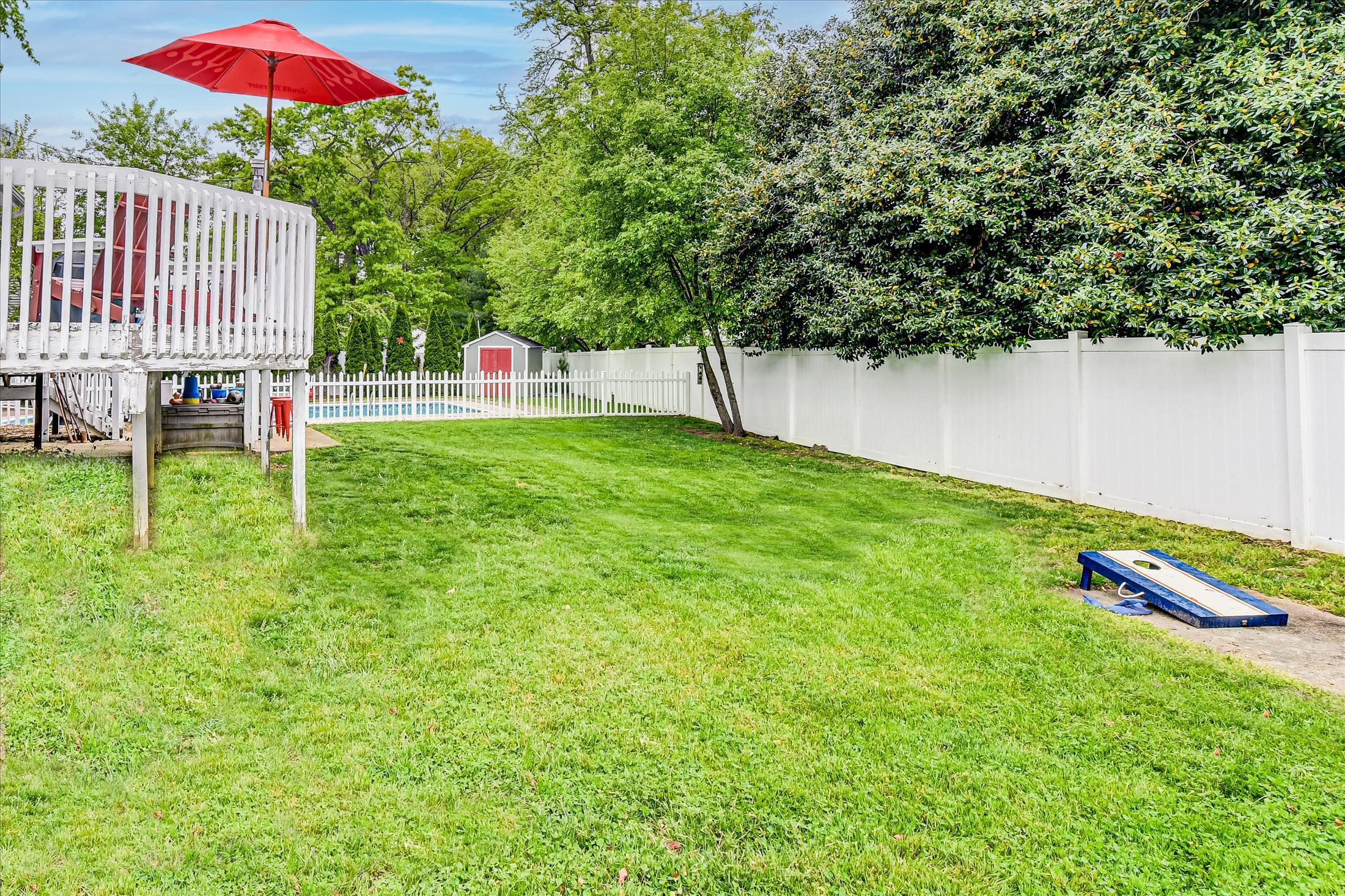 675 Harmony Road Middletown, NJ 07748 - Photo 21 of 25 a backyard of a house with table and chairs
