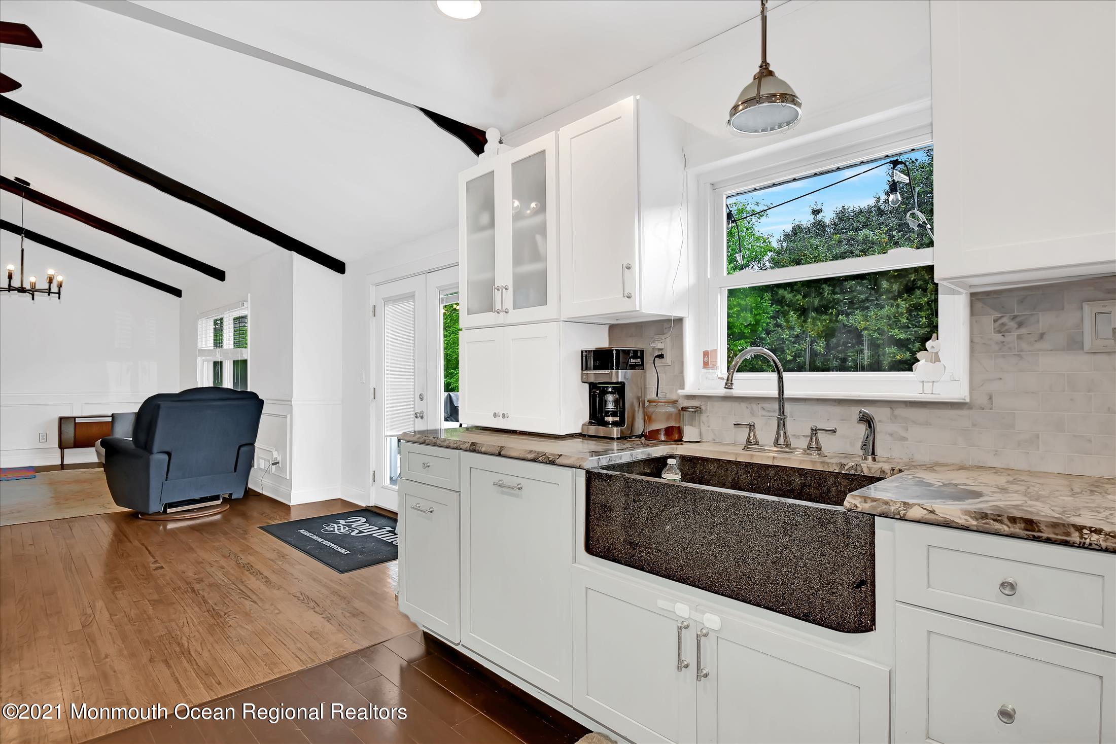 675 Harmony Road Middletown, NJ 07748 - Photo 5 of 25 a kitchen with a stove a sink and a granite counter top