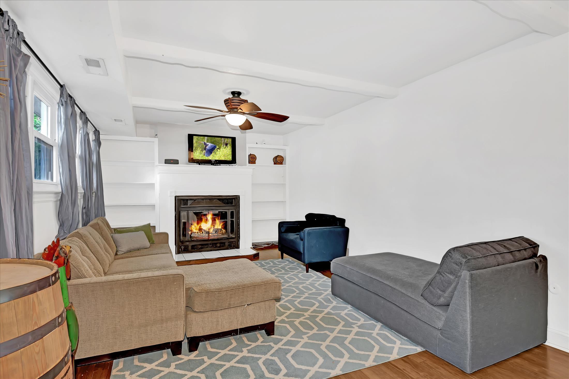 675 Harmony Road Middletown, NJ 07748 - Photo 8 of 25 a living room with furniture and a fireplace