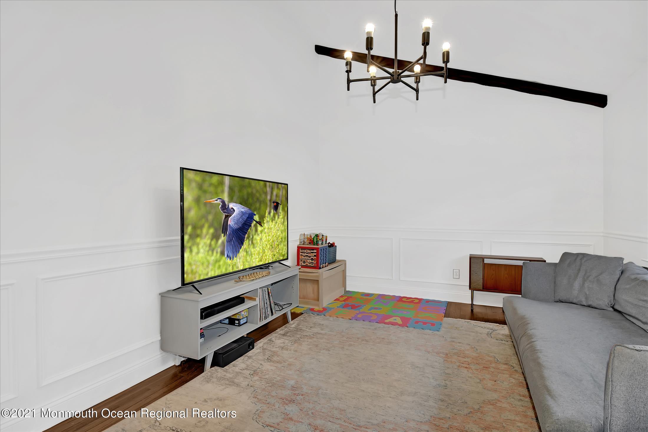 675 Harmony Road Middletown, NJ 07748 - Photo 10 of 25 a living room with furniture and a flat screen tv