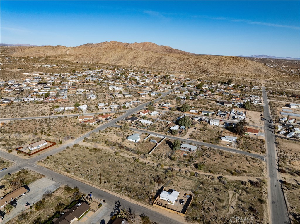 61954 Plaza Road Joshua Tree, CA 92252 - Photo 11 of 23 an aerial view of house with yard and mountain view in back