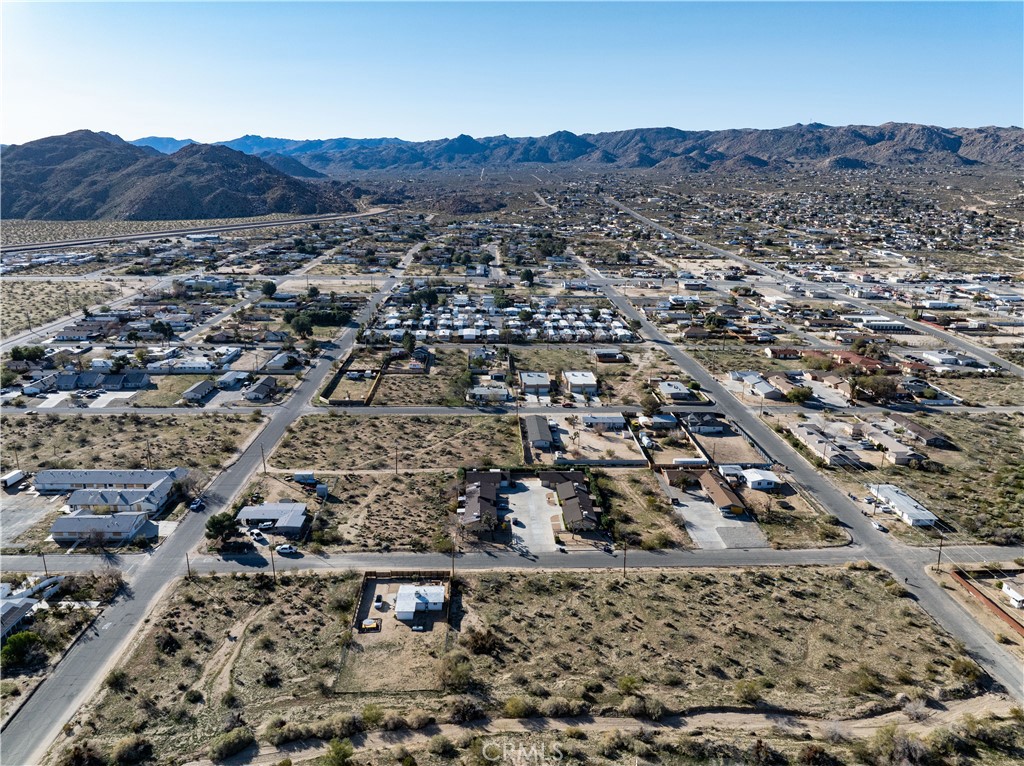 61954 Plaza Road Joshua Tree, CA 92252 - Photo 14 of 23 an aerial view of residential house and green space