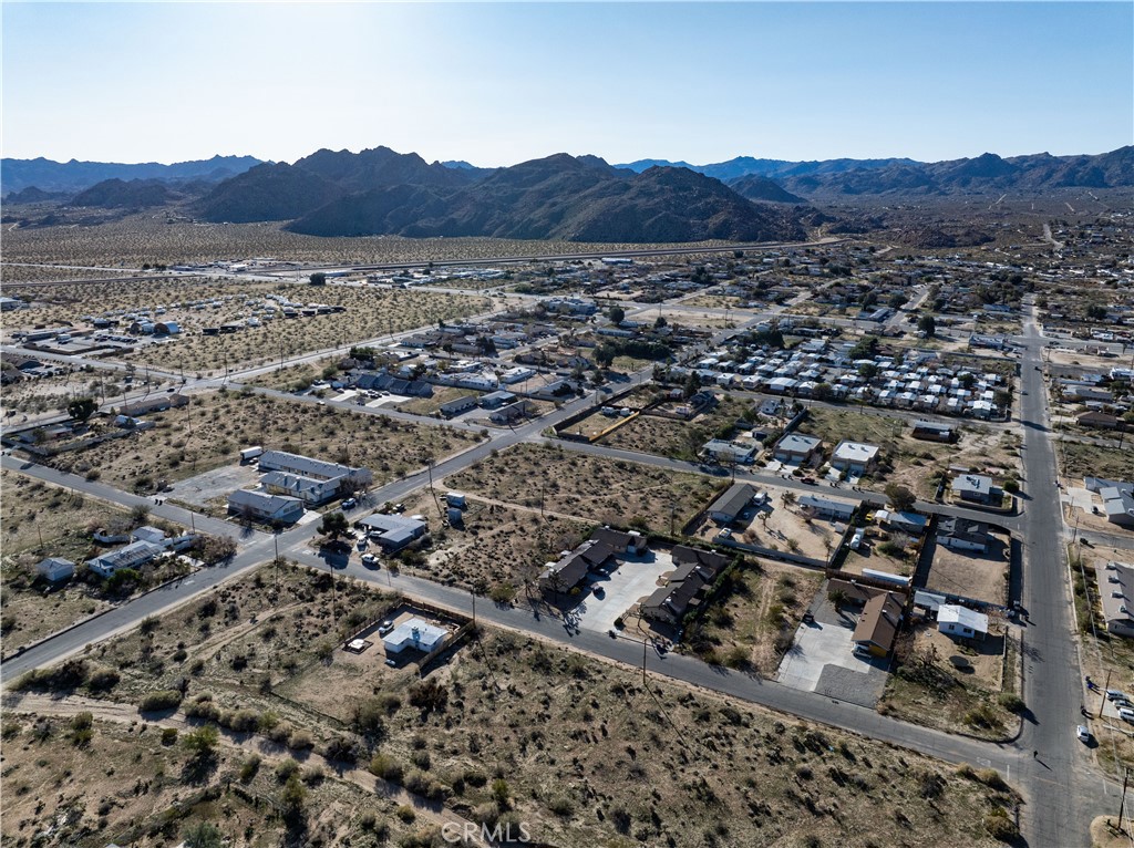 61954 Plaza Road Joshua Tree, CA 92252 - Photo 15 of 23 an aerial view of residential house and sandy dunes