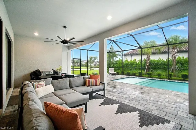 a living room with furniture and a floor to ceiling window