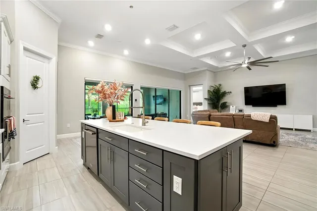 a large white kitchen with a large window