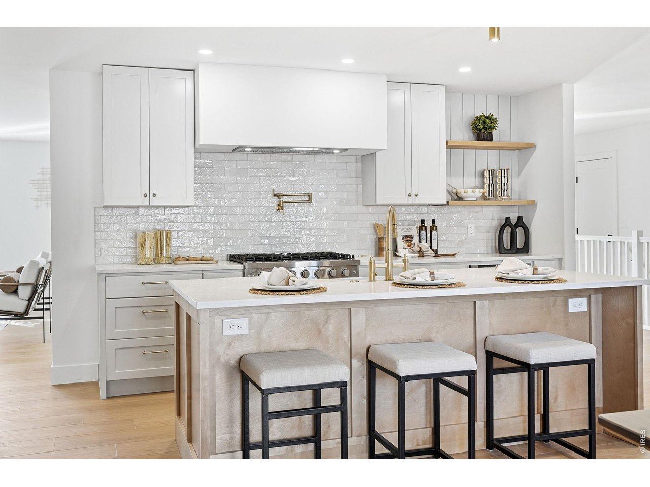 4788 Briar Ridge Trail Boulder, CO 80301 - Photo 6 of 45 A generous center island showcases quartz countertops, a farmhouse sink, and bar seating for three, anchoring the kitchen with both style and functionality.