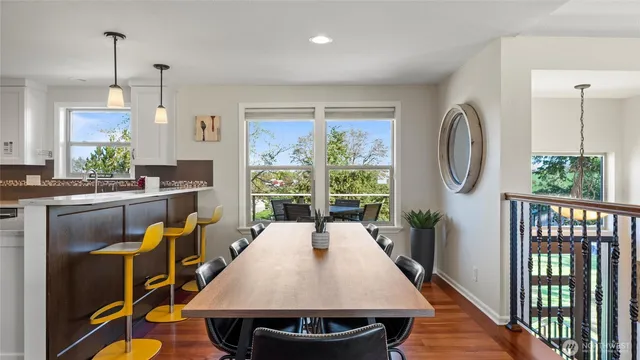 a kitchen with a sink a stove and chairs in it