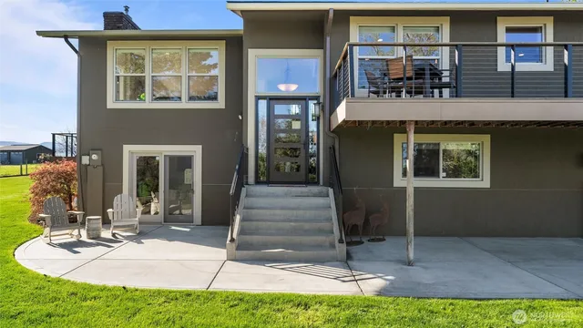 a view of staircase with lots of frames on wall and a large window