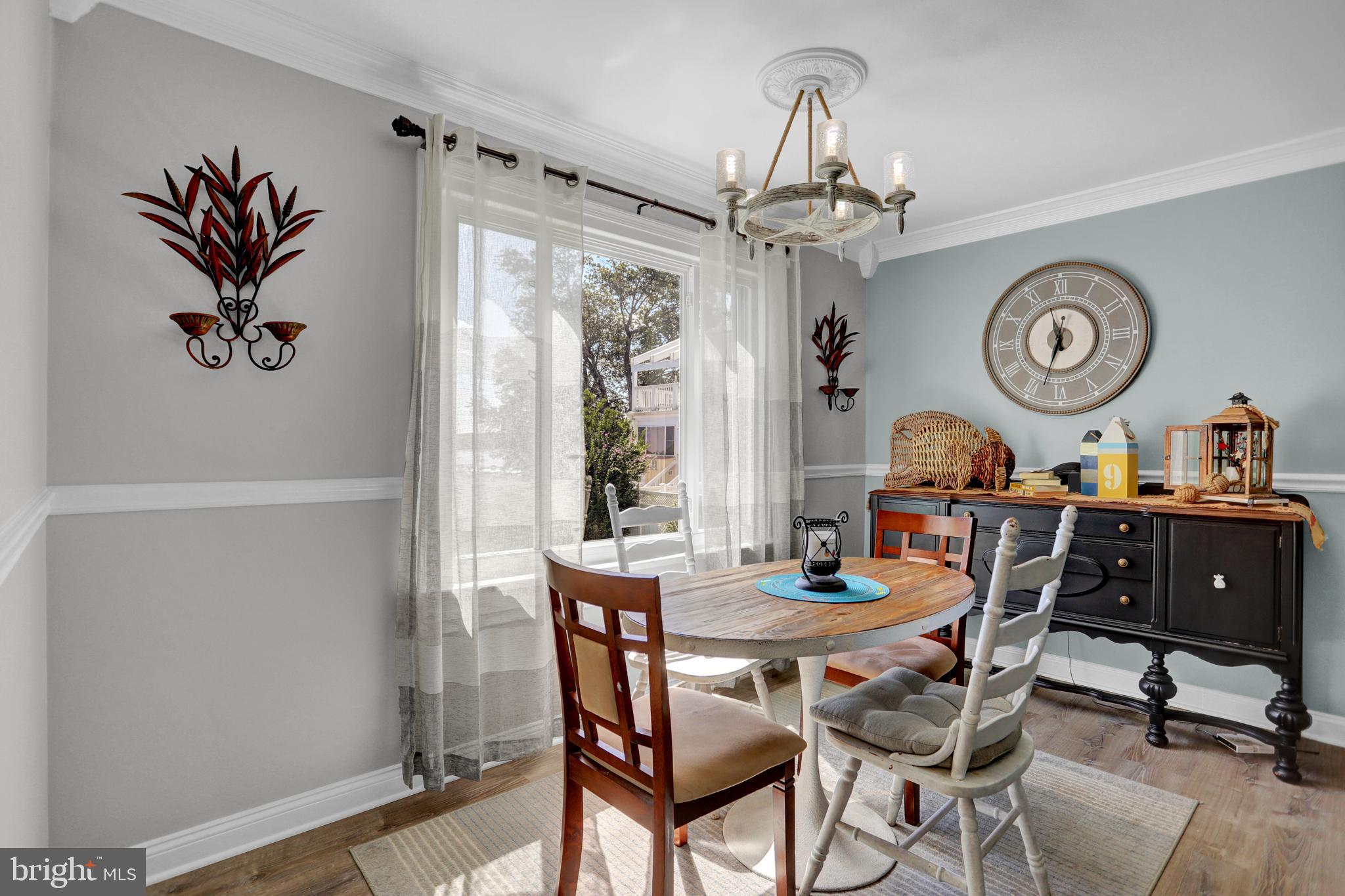 4017 East Baker Avenue Abingdon, MD 21009 - Photo 18 of 86 a view of a dining room with furniture a chandelier and a window
