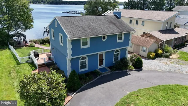 a aerial view of a house with a yard table and chairs