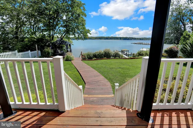 an aerial view of lake and residential houses with outdoor space