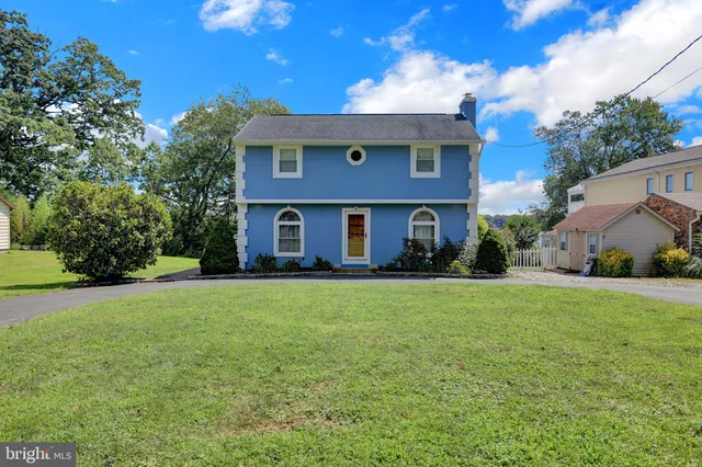a kitchen with stainless steel appliances kitchen island granite countertop a stove a sink and a refrigerator