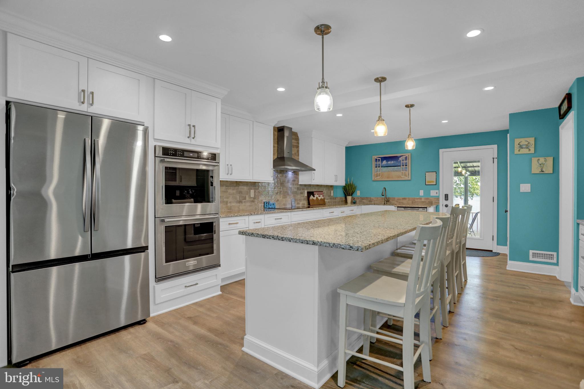 4017 East Baker Avenue Abingdon, MD 21009 - Photo 8 of 86 a kitchen with stainless steel appliances granite countertop a refrigerator a sink dishwasher a stove and a refrigerator with wooden floor