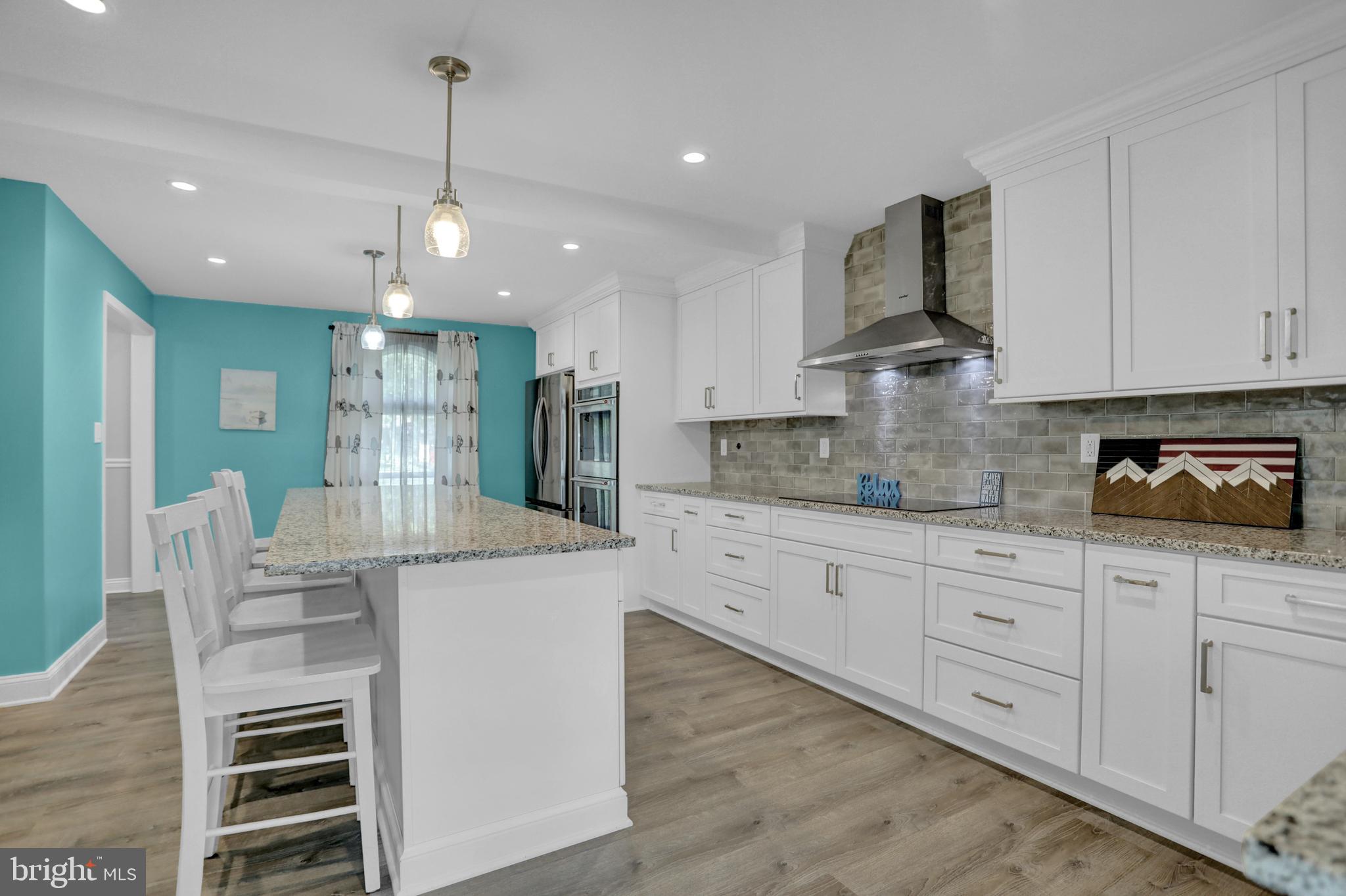 4017 East Baker Avenue Abingdon, MD 21009 - Photo 9 of 86 a kitchen with stainless steel appliances kitchen island granite countertop a stove a sink and a refrigerator