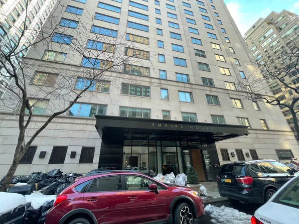a front view of a building with parking space