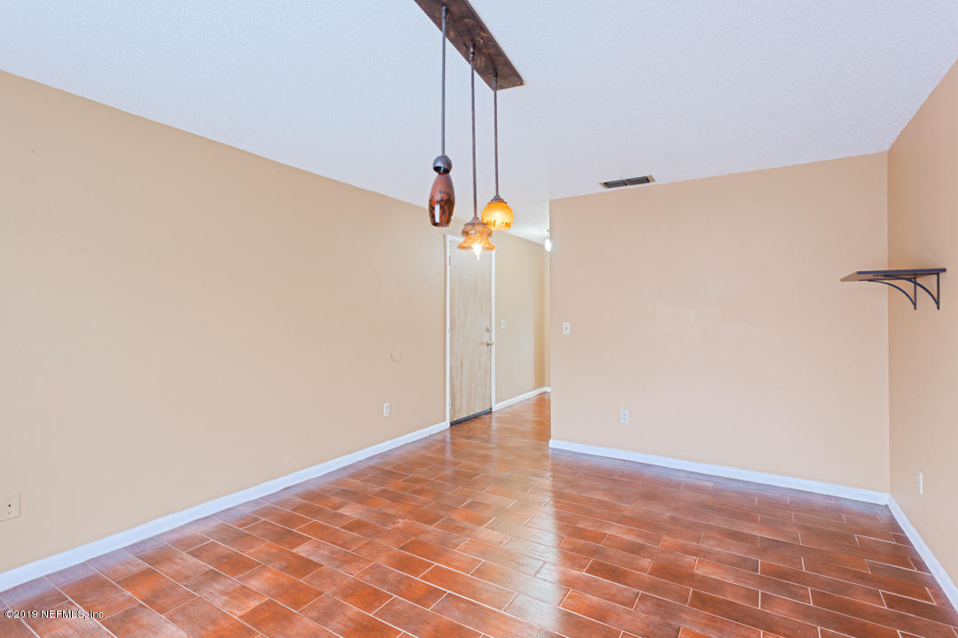 8759 Moss Haven Road Jacksonville, FL 32221 - Photo 14 of 29 a view of a room with wooden floor and white walls