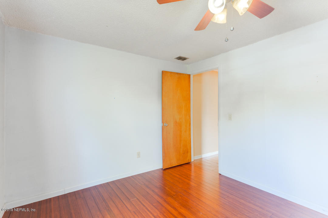 8759 Moss Haven Road Jacksonville, FL 32221 - Photo 21 of 29 a view of empty room with wooden floor