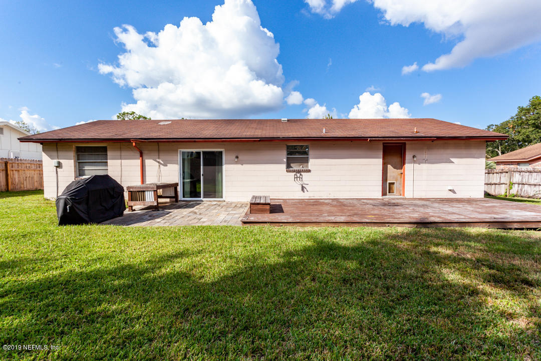 8759 Moss Haven Road Jacksonville, FL 32221 - Photo 28 of 29 a view of a white house with a big yard and a large tree