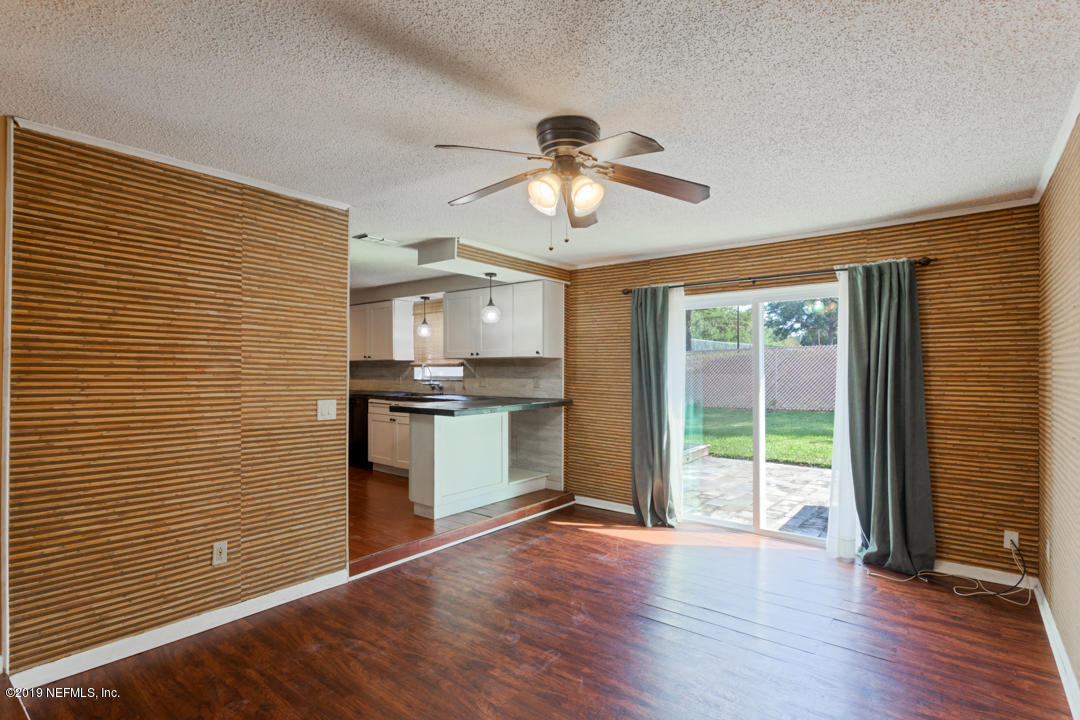 8759 Moss Haven Road Jacksonville, FL 32221 - Photo 5 of 29 a view of kitchen with refrigerator and wooden floor