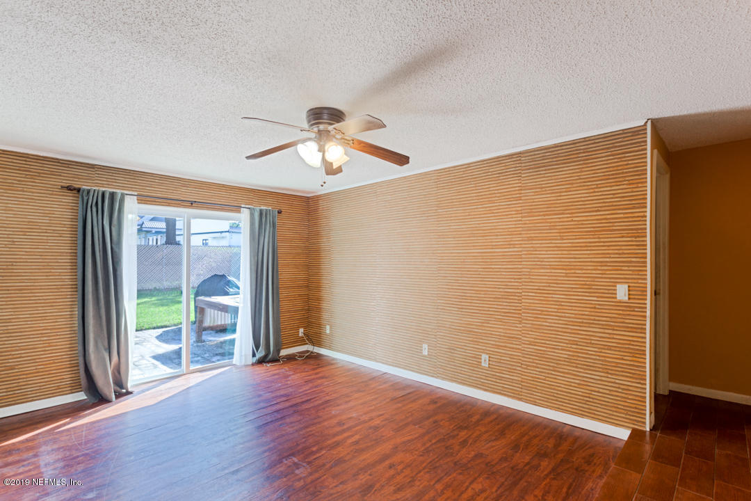 8759 Moss Haven Road Jacksonville, FL 32221 - Photo 6 of 29 a view of an empty room with a window and wooden floor