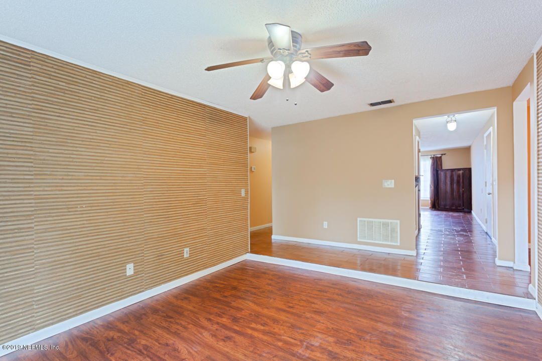 8759 Moss Haven Road Jacksonville, FL 32221 - Photo 7 of 29 wooden floor in an empty room with a window