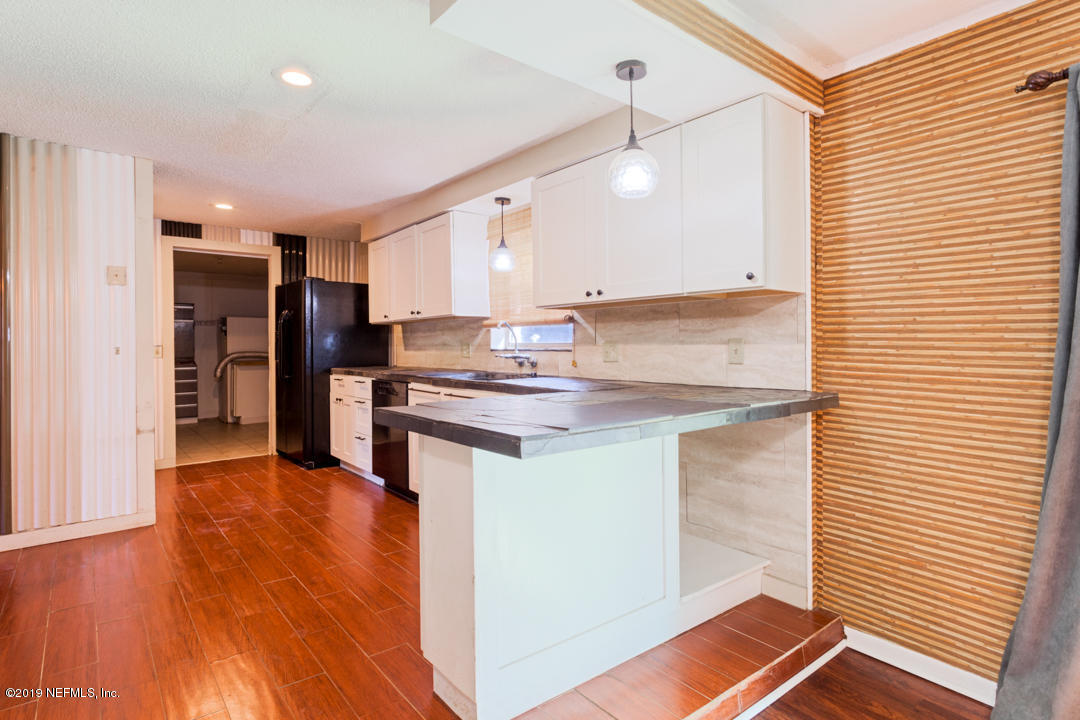 8759 Moss Haven Road Jacksonville, FL 32221 - Photo 8 of 29 a open kitchen with stainless steel appliances granite countertop a refrigerator and a stove top oven