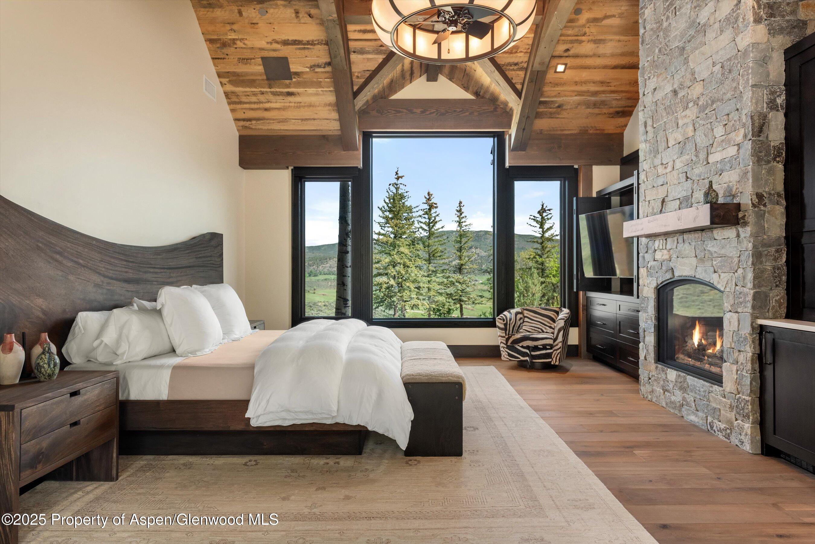 2318 Lazy O Road Snowmass, CO 81654 - Photo 11 of 50 a bed room with a bed and a couch