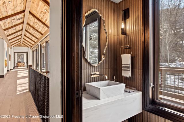 a bathroom with a toilet a sink and a mirror