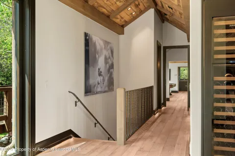 a view of a hallway with paintings on the wall