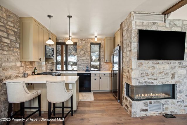 a kitchen with stainless steel appliances kitchen island granite countertop a sink and cabinets