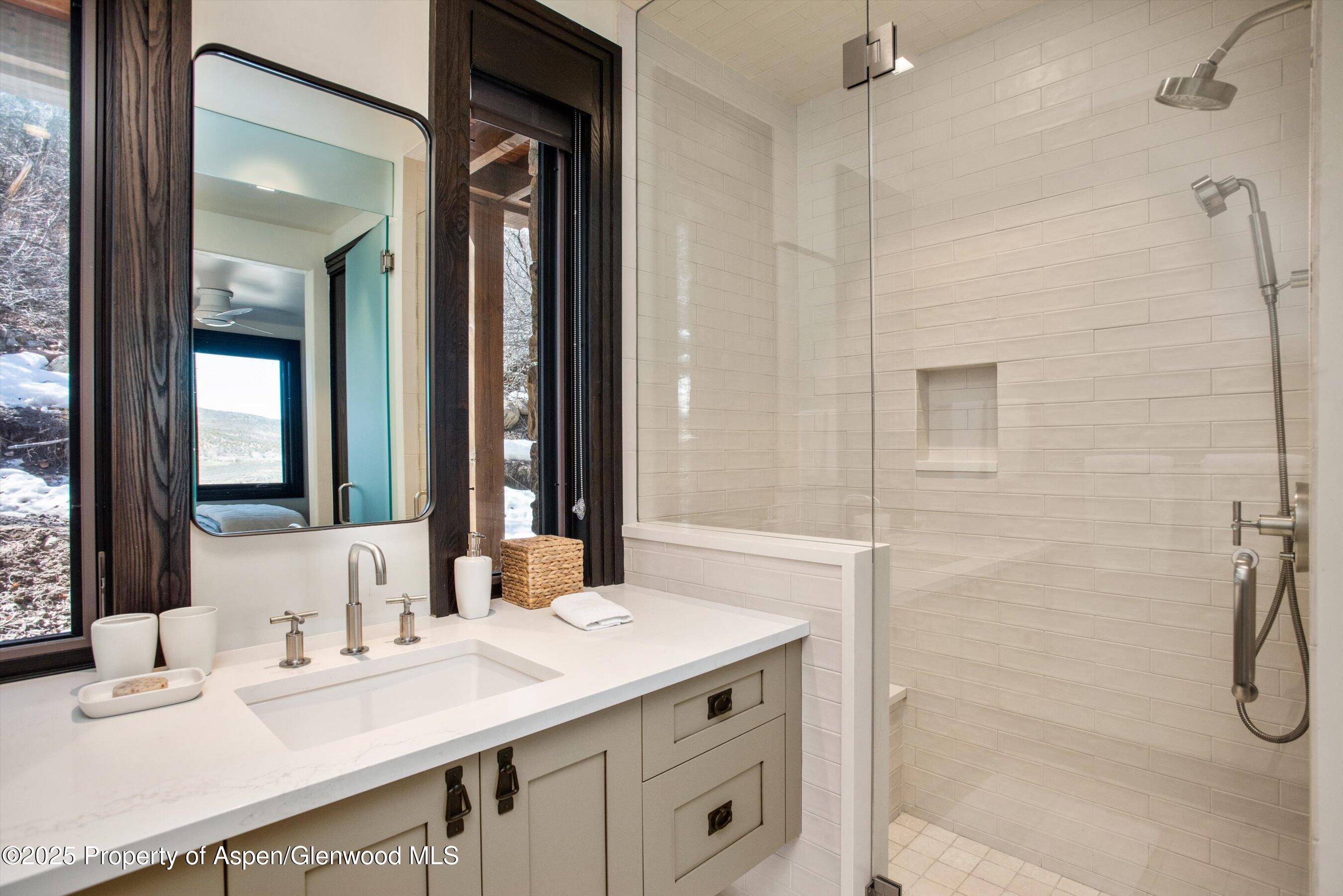 2318 Lazy O Road Snowmass, CO 81654 - Photo 28 of 50 a bathroom with a granite countertop sink mirror and a shower
